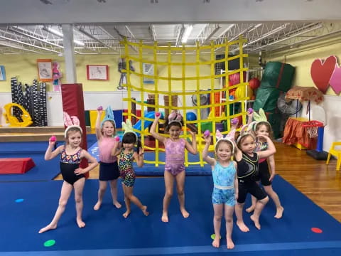 a group of girls posing for a picture in a play room