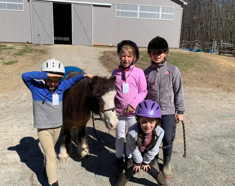 a group of people with a horse