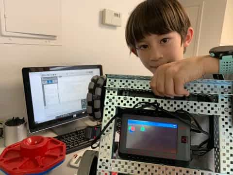 a boy sitting at a computer