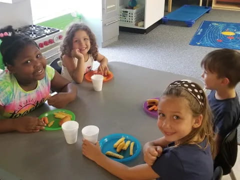 a group of children sitting at a table