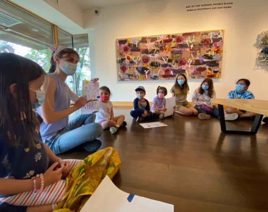 a group of children sitting in a classroom