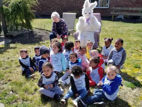a group of children posing for a photo with a rabbit