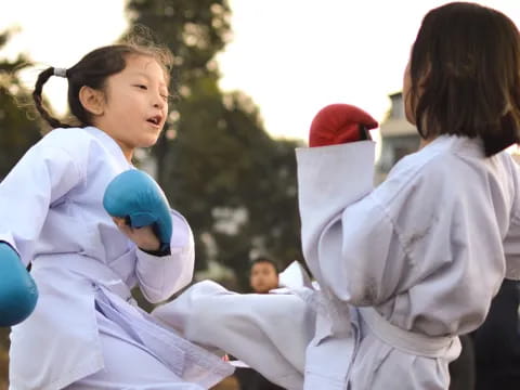 a few children in karate uniforms