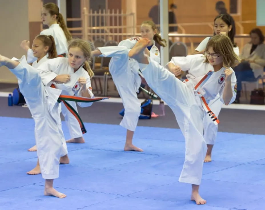 a group of children practicing karate