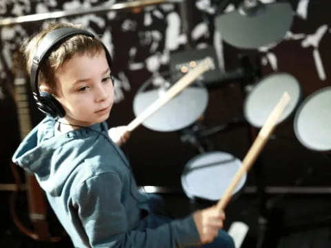 a young girl playing drums