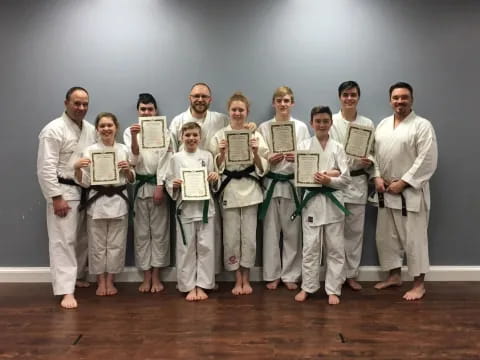 a group of people holding certificates