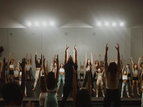 a group of people holding their hands up in the air