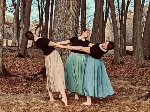 a group of people dancing in a forest