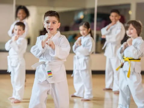 a group of children in karate uniforms