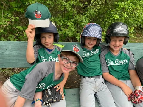 a group of kids wearing baseball hats
