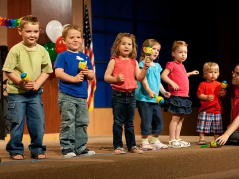 a group of children standing on a stage