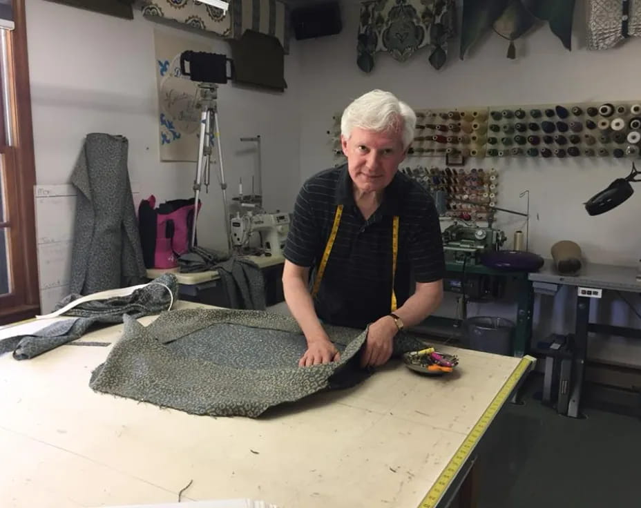 a man standing next to a large fish on a table