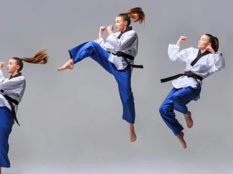 a group of people in blue jumpsuits jumping in the air