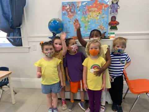 a group of children holding balloons