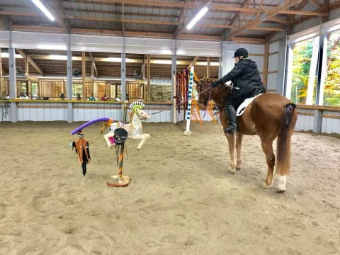 a person riding a horse in a barn