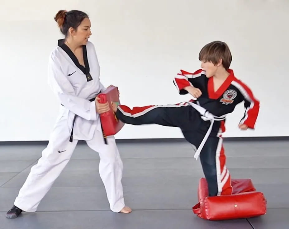 a person and a boy in karate uniforms