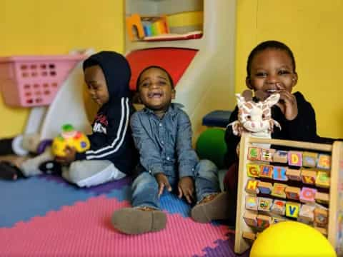 a group of children sitting on the floor with toys