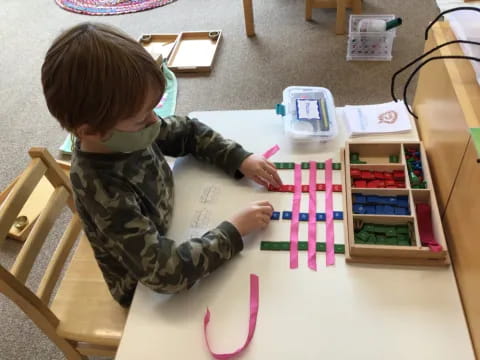 a child coloring on a table