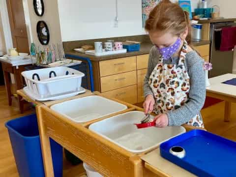 a girl painting a table