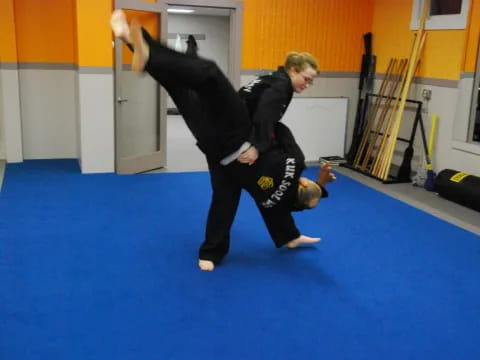 a man and a woman practicing martial arts