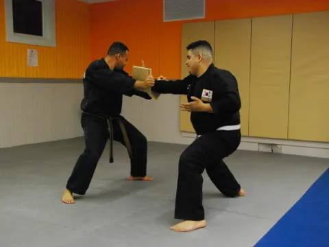 two men in black martial arts uniforms