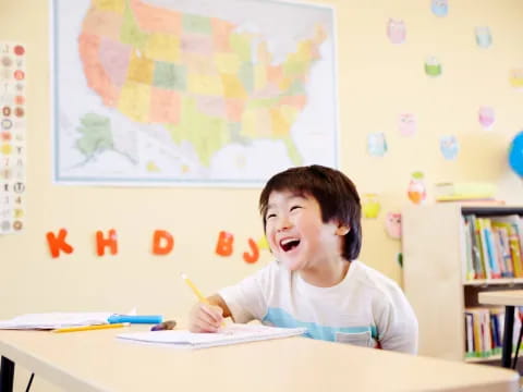 a boy sitting at a desk