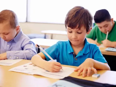 a few young boys studying in a classroom