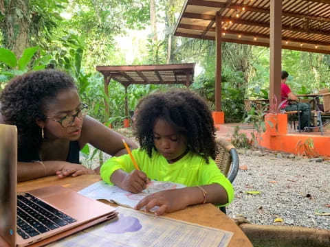 a person and a girl studying outside