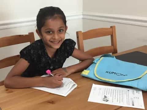 a girl sitting at a table