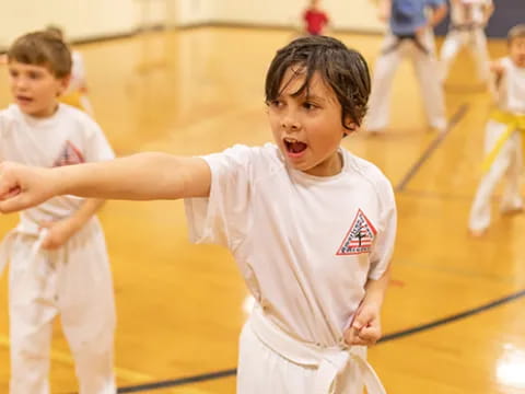 a group of kids in karate uniforms