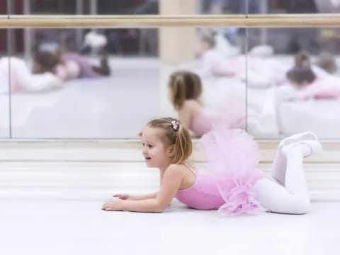 a girl in a tutu on the floor