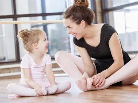 a woman and a child sitting on the floor