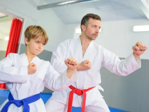 a man and a boy in karate uniforms