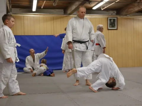 a group of people in white karate uniforms