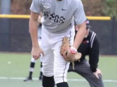 a baseball player holding a ball