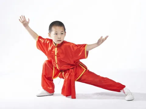 a young boy in a red suit