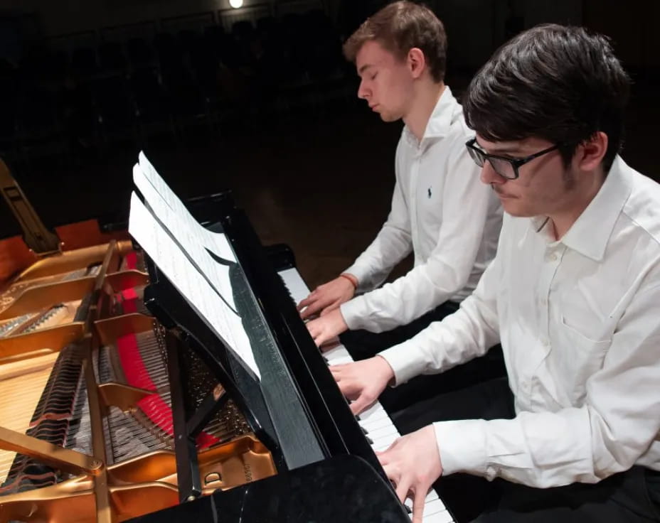 a couple of men playing musical instruments