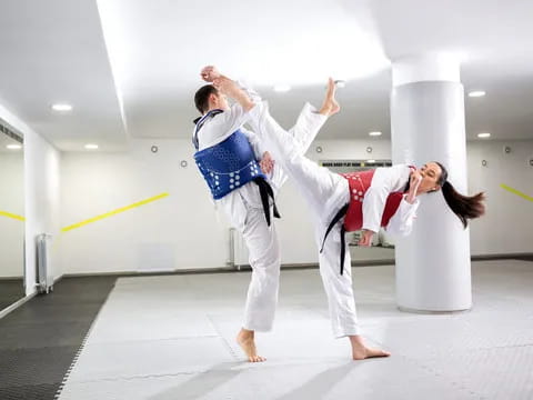 a man and woman in karate uniforms