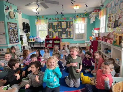 a group of children sitting in a classroom