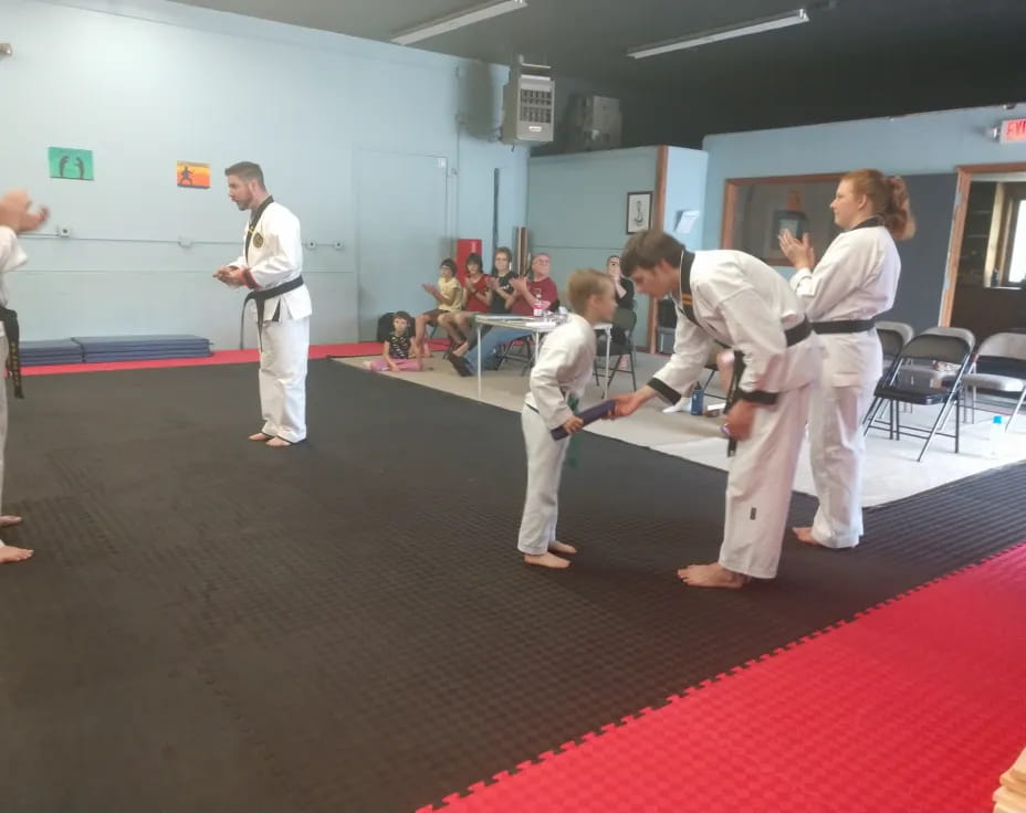 a group of people in karate uniforms