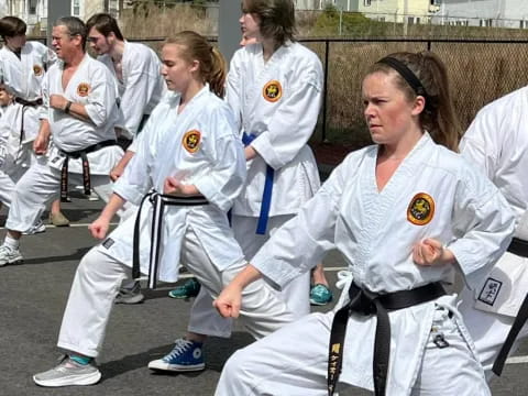 a group of women in karate uniforms