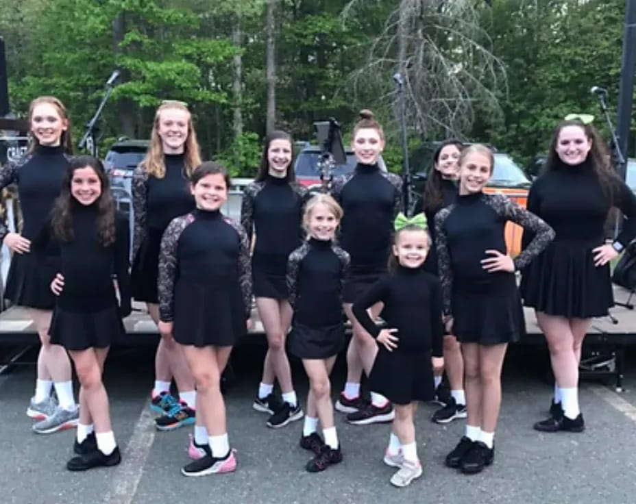 a group of girls in black dresses