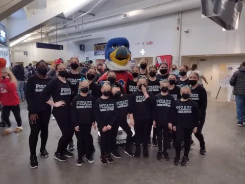a group of people wearing black shirts and black shirts with a cartoon character on them