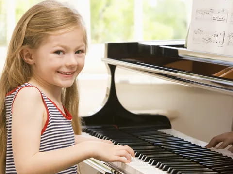 a girl playing a piano