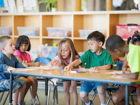 a group of children sitting at a table