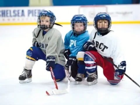 a group of people playing hockey