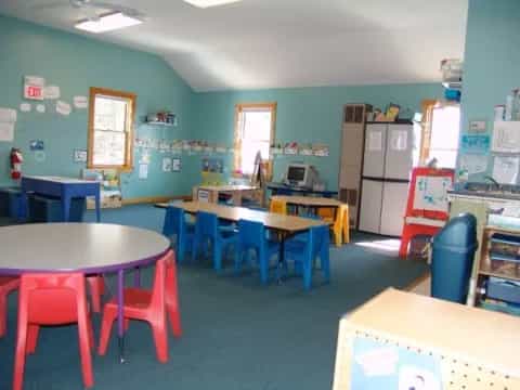 a classroom with tables and chairs