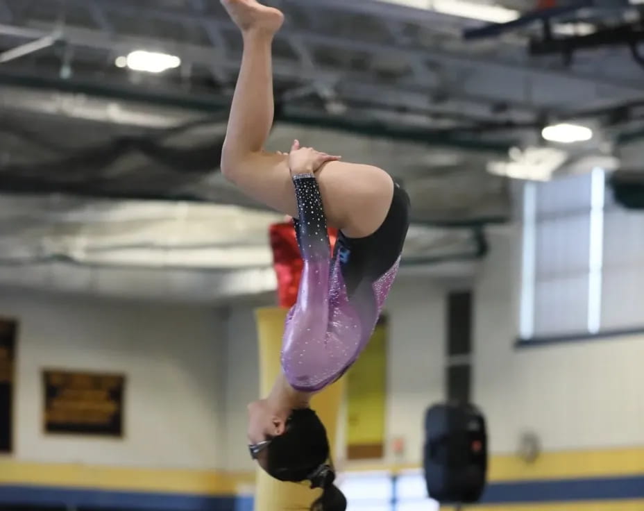 a woman doing a handstand