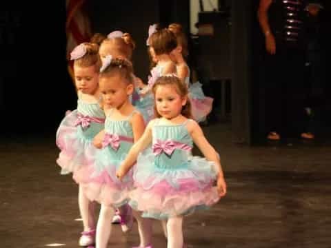 a group of girls in dresses