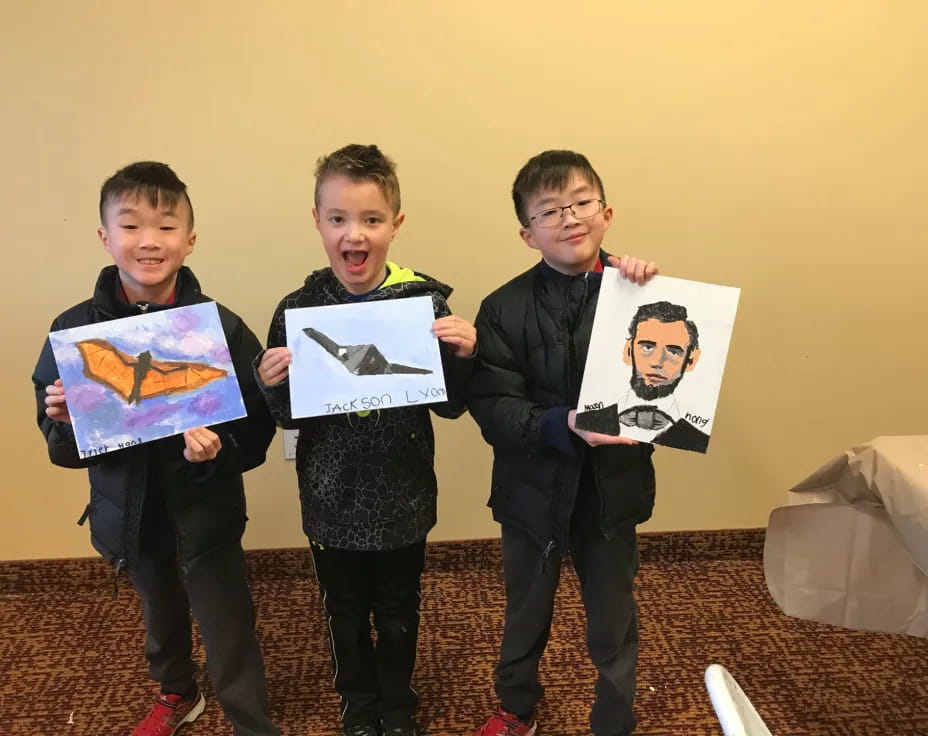 a group of boys holding up posters